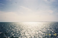 the sun is shining on the water