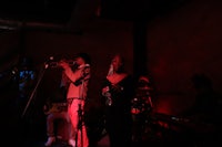 a group of people playing music in a dark room