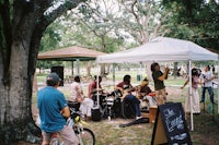 a group of people playing music in a park