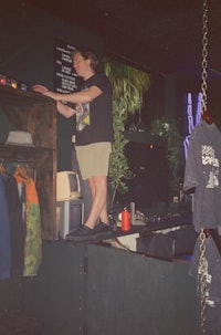 a man standing on top of a shelf in a store