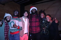 a group of people in santa hats posing for a photo