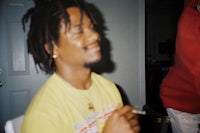 a man with dreadlocks smoking a cigarette