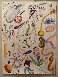 a drawing of a face with colored pencils on it