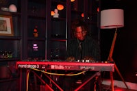 a man playing an electronic keyboard in a room