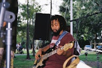 a man playing a bass guitar