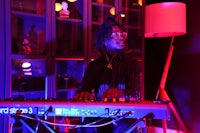 a man playing a keyboard in a dark room