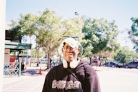 a man wearing headphones and a skateboard